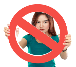 Close Up Of Young Woman Holding Prohibited Sign